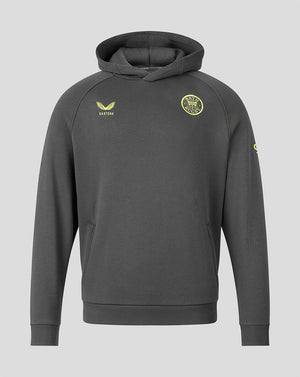 A dark gray pullover hoodie with yellow-green printed logos, including a circular crest on the left chest and a winged logo on the right chest, displayed against a solid light gray background.