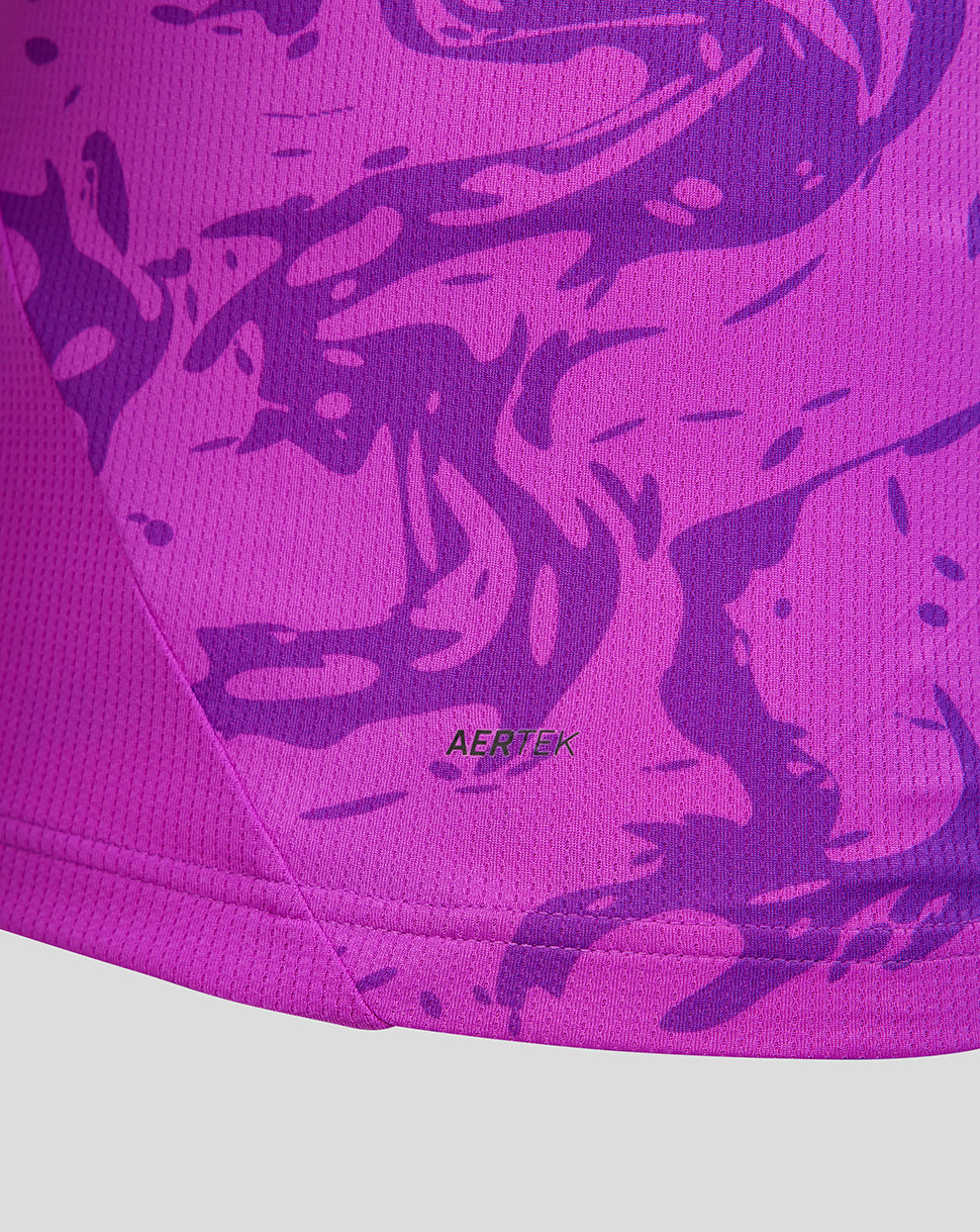 Close-up of a purple athletic top with a camouflage pattern and 'AERTEK' branding.