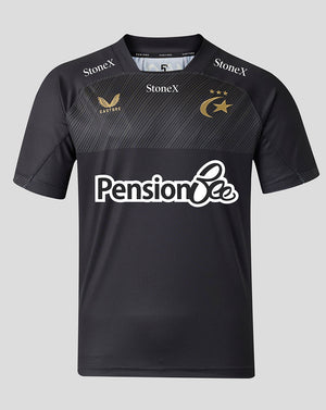 A black short-sleeve sports jersey with a subtle diagonal textured pattern across the chest. It features the white 'Pension Bee' sponsor logo across the center, 'StoneX' branding on the shoulders, and gold embroidered logos for 'Castore' and the Saracens club emblem on the chest.