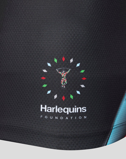 Close-up of a black athletic garment featuring the 'Harlequins Foundation' logo with a colorful DNA helix and white text on the front.