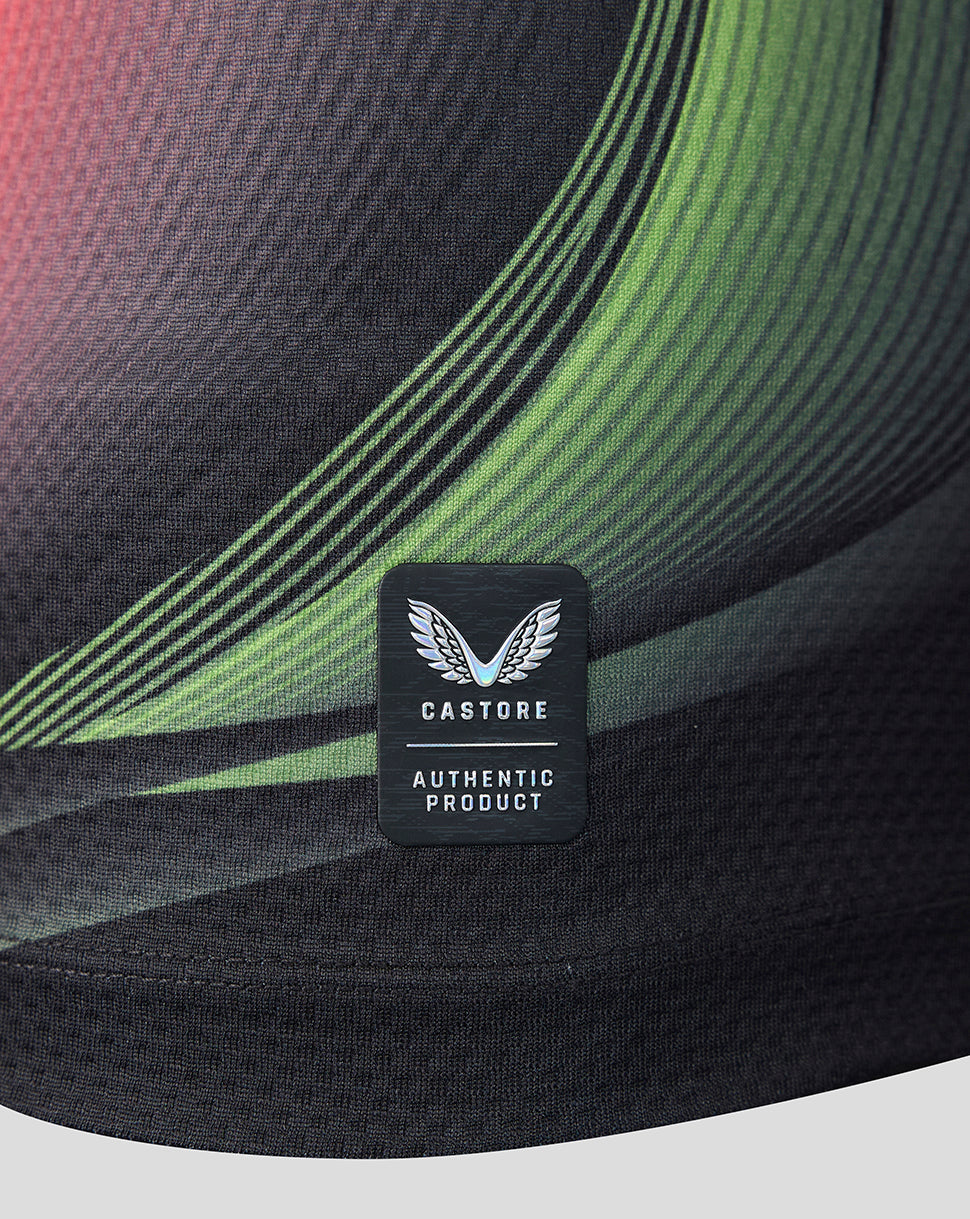 Close-up of a black athletic cap featuring a green and black wavy pattern and a black Castore Authentic Product patch on the front.