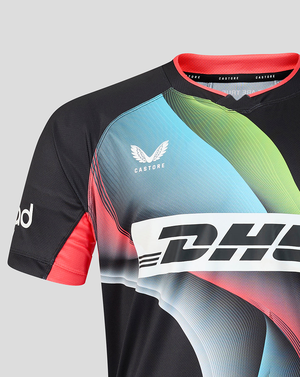 A close-up of a Castore rugby jersey with a black base, featuring a vibrant graphic pattern in light blue, green, and pink, with a large white DHL logo across the chest.