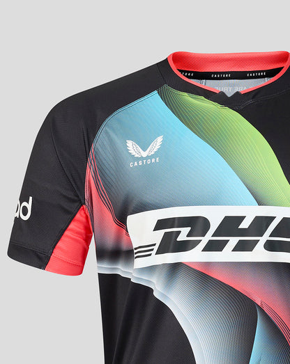 A close-up of a Castore rugby jersey with a black base, featuring a vibrant graphic pattern in light blue, green, and pink, with a large white DHL logo across the chest.