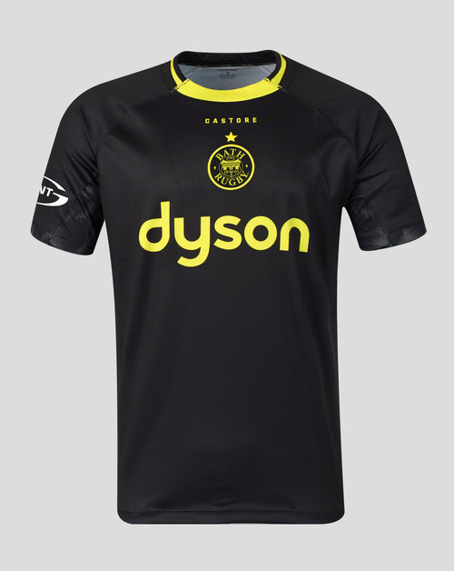 A black short-sleeve athletic jersey with a yellow collar, featuring the yellow Castore logo and Bath Rugby crest on the chest, displayed against a solid gray background.