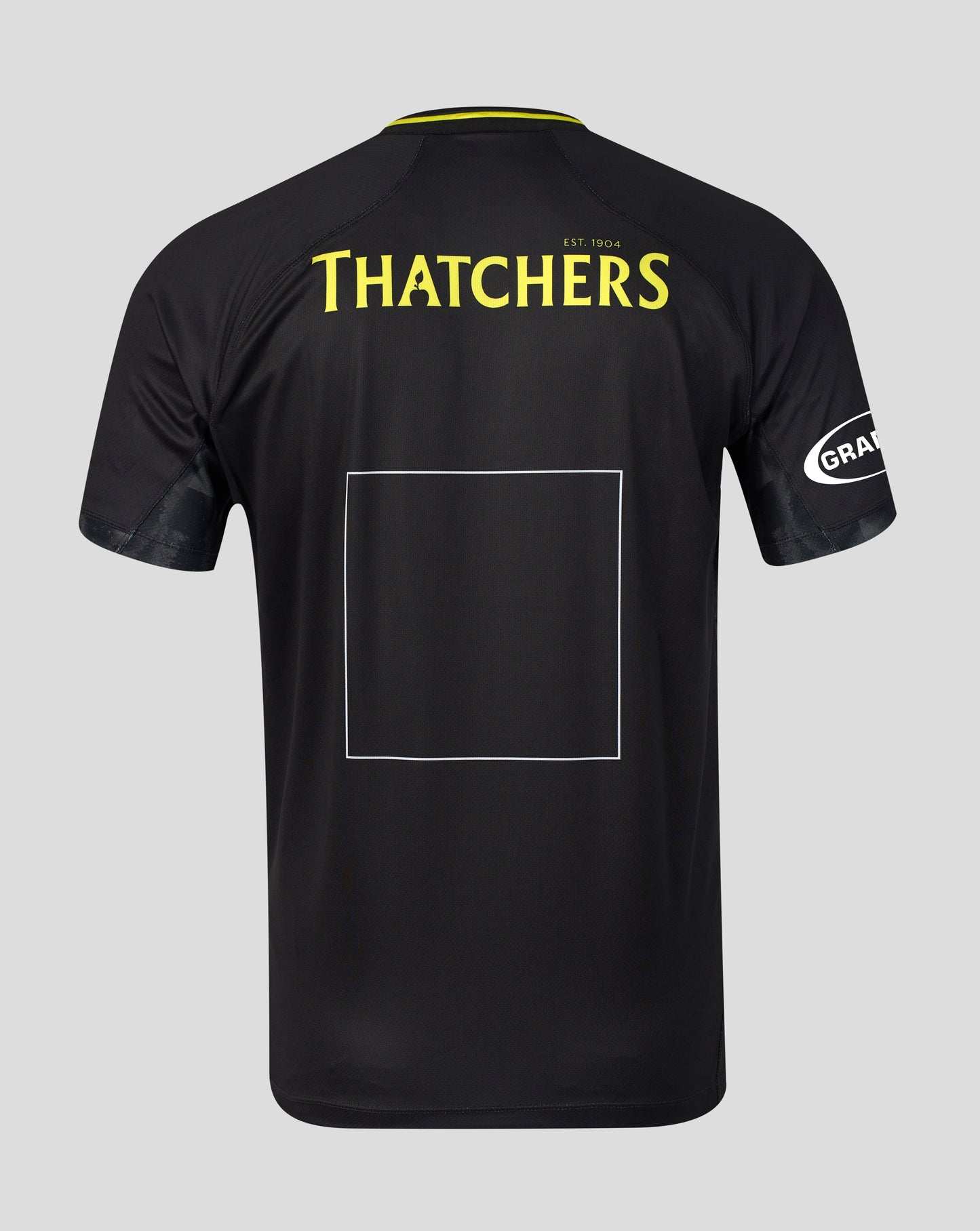 Black short-sleeve sports jersey shown from the back on a light gray background, featuring 'THATCHERS' in yellow text across the upper back, a large blank rectangular patch area in the center, and a white circular 'GRA' logo on the sleeve.