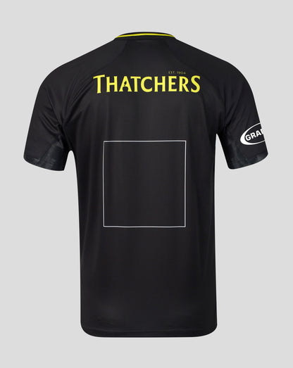 Black short-sleeve sports jersey shown from the back on a light gray background, featuring 'THATCHERS' in yellow text across the upper back, a large blank rectangular patch area in the center, and a white circular 'GRA' logo on the sleeve.