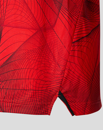 Close-up of red Feyenoord home shirt fabric with a dark geometric line pattern
