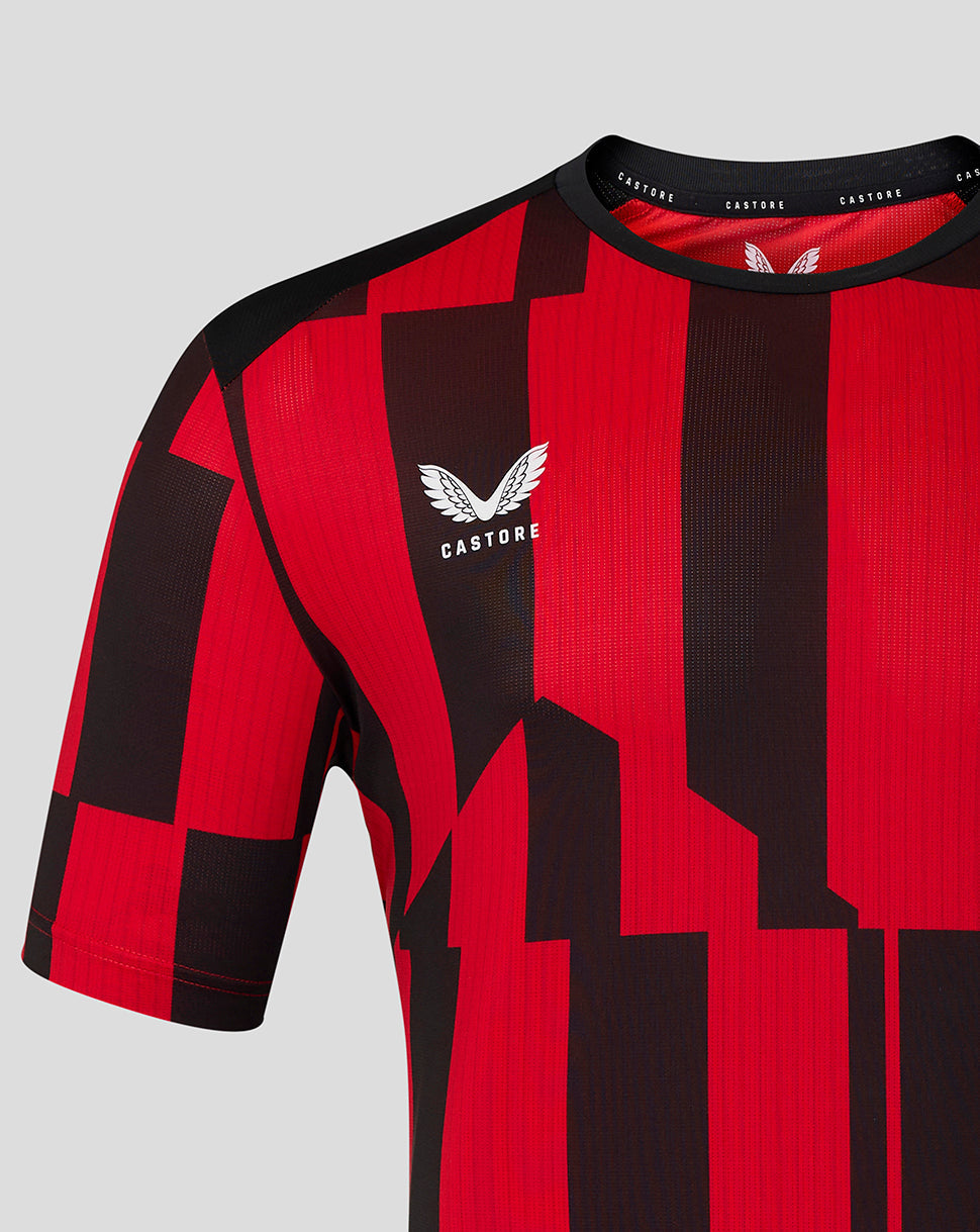 Close up of red and black geometric matchday shirt with Castore logo on chest.