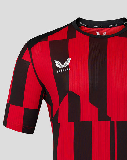 Close up of red and black geometric matchday shirt with Castore logo on chest.