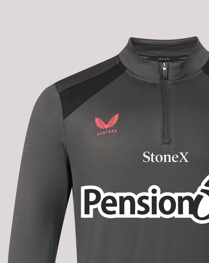 A close-up of a dark gray long-sleeve athletic quarter-zip pullover with black shoulder panels. The chest features a red winged logo with 'CASTORE' underneath, and white sponsor logos 'StoneX' and 'Pension' printed across the front.
