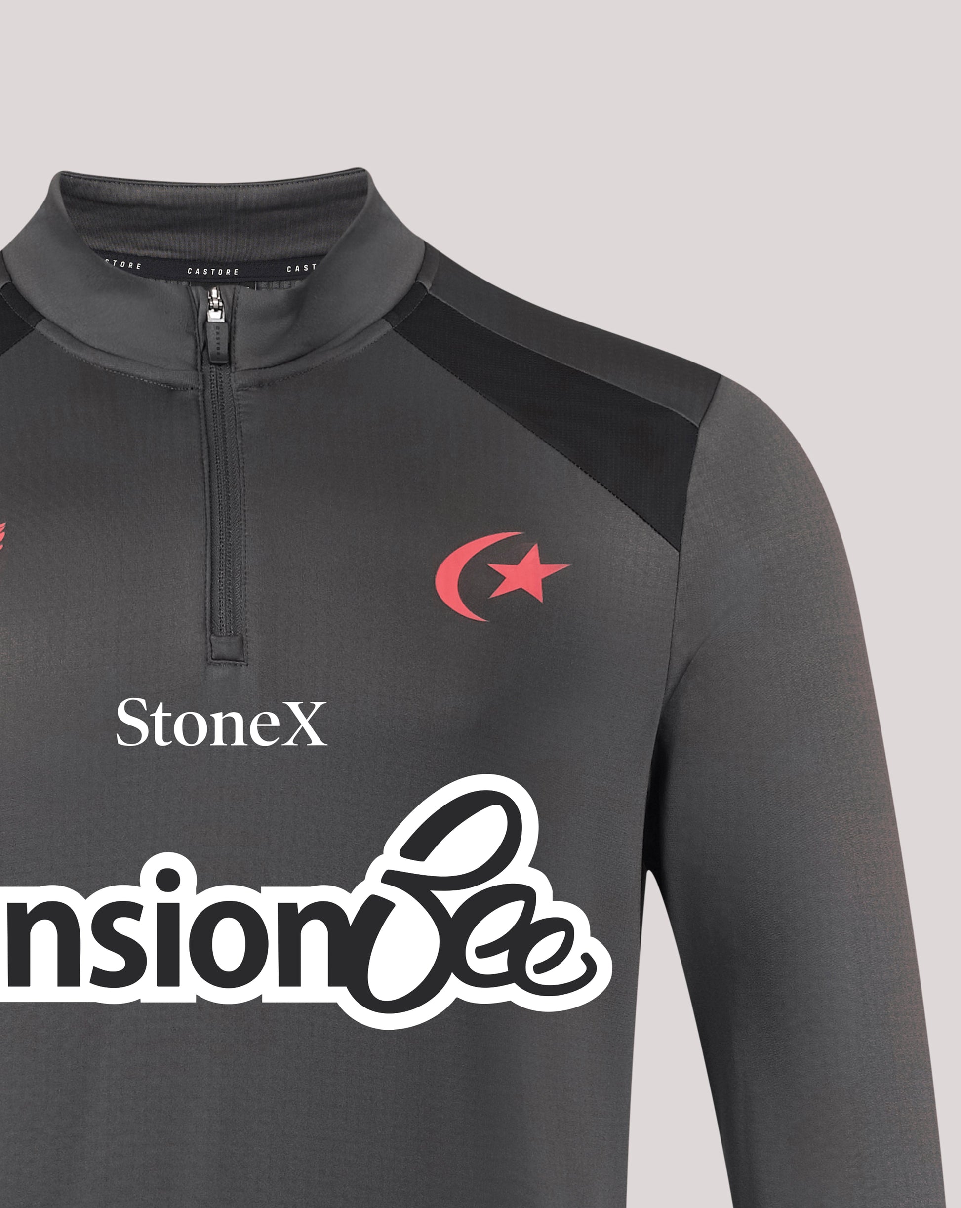 A close-up of a dark gray long-sleeve athletic quarter-zip pullover with a mock neck. The garment features a red crescent and star logo on the left chest, the brand name 'StoneX' in white, and a large white sponsor logo across the lower front.