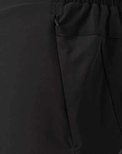 Close-up of black textured fabric with an elastic waistband and a side zipper pocket.