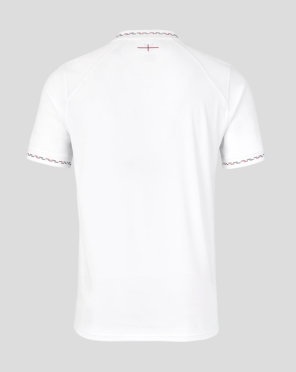White t-shirt with decorative trim on a light gray background