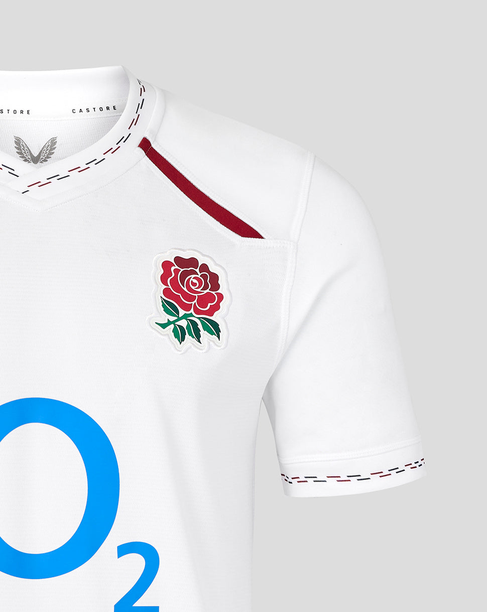 White sports jersey with a red rose emblem and 'O2' branding on a gray background