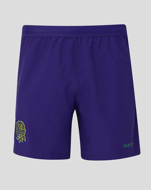 Purple shorts with a green logo on a gray background