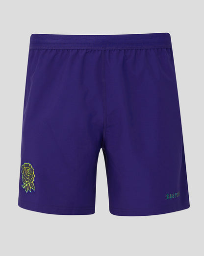 Purple shorts with a green logo on a gray background