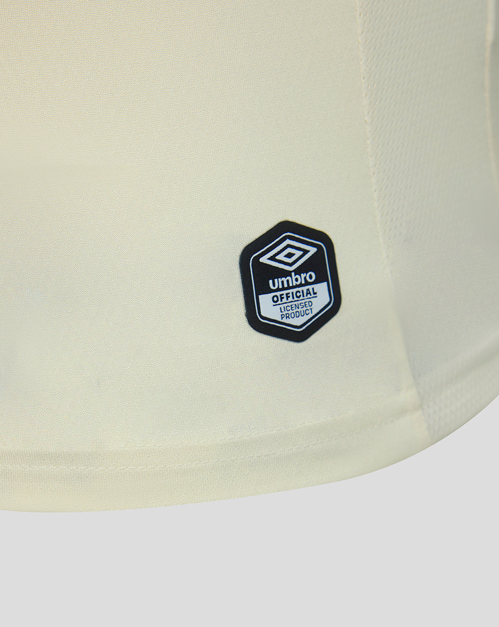 Close-up of a light-colored shirt with an Umbro logo on a white background