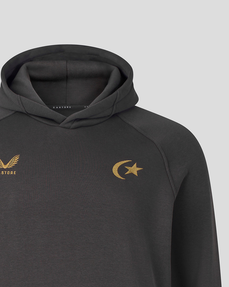 A close-up of a dark gray athletic hoodie featuring a gold crescent moon and star logo on the left chest and a gold winged emblem with 'CASTORE' on the right chest, set against a light gray background.