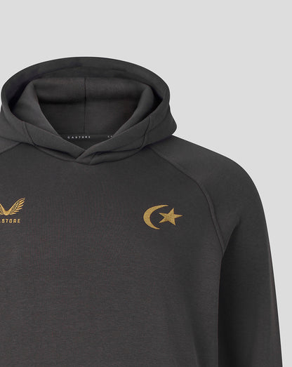 A close-up of a dark gray athletic hoodie featuring a gold crescent moon and star logo on the left chest and a gold winged emblem with 'CASTORE' on the right chest, set against a light gray background.