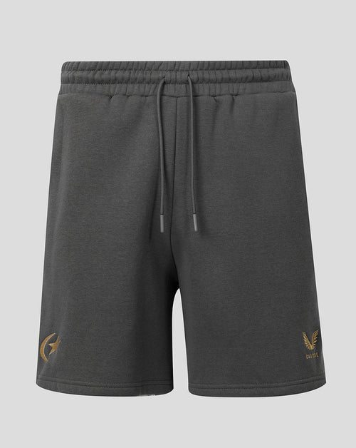 Dark gray heathered sweat shorts with a drawstring waist, featuring a gold winged logo on the left leg and a small gold 'CASTORE' brand mark on the right leg, shown against a light gray background.