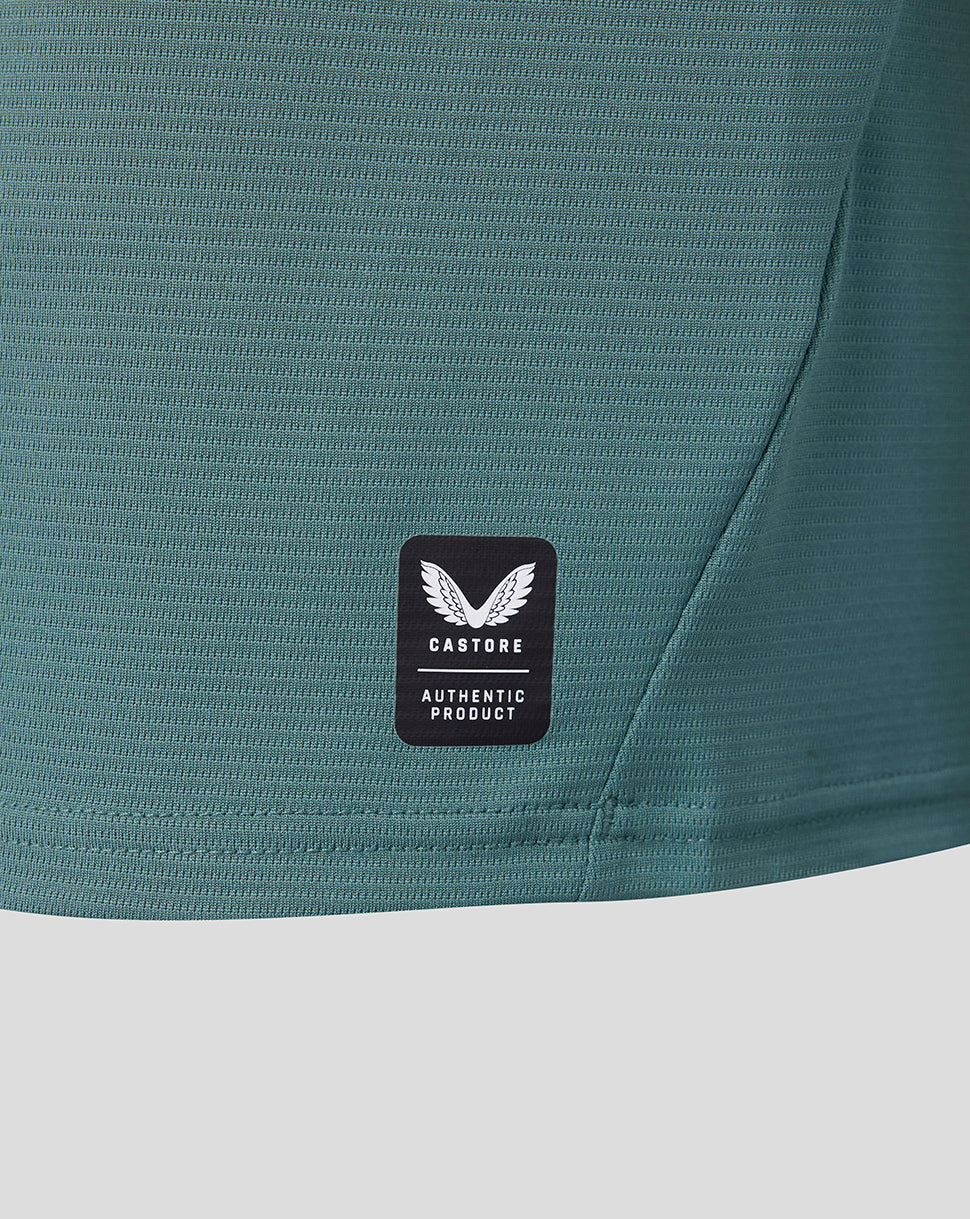 Close up of teal fabric with Castore authentic product badge