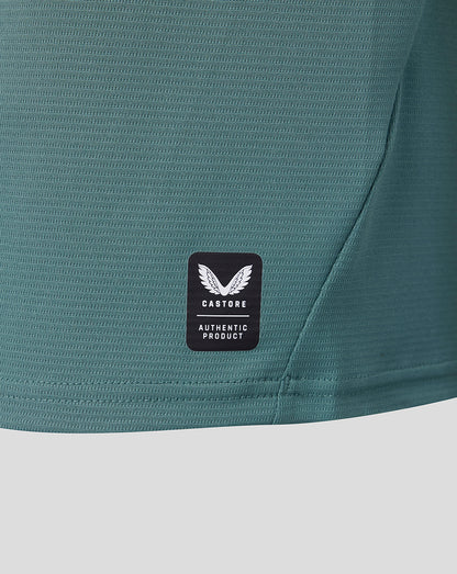 Close up of teal fabric with Castore authentic product badge