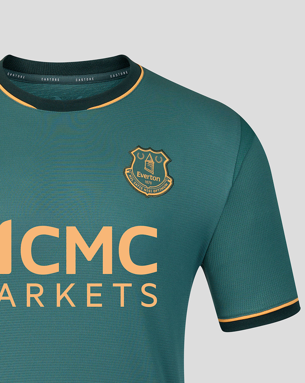 Shoulder and chest close up of teal Everton 26/27 third shirt featuring the club crest and large MCMC MARKETS logo.