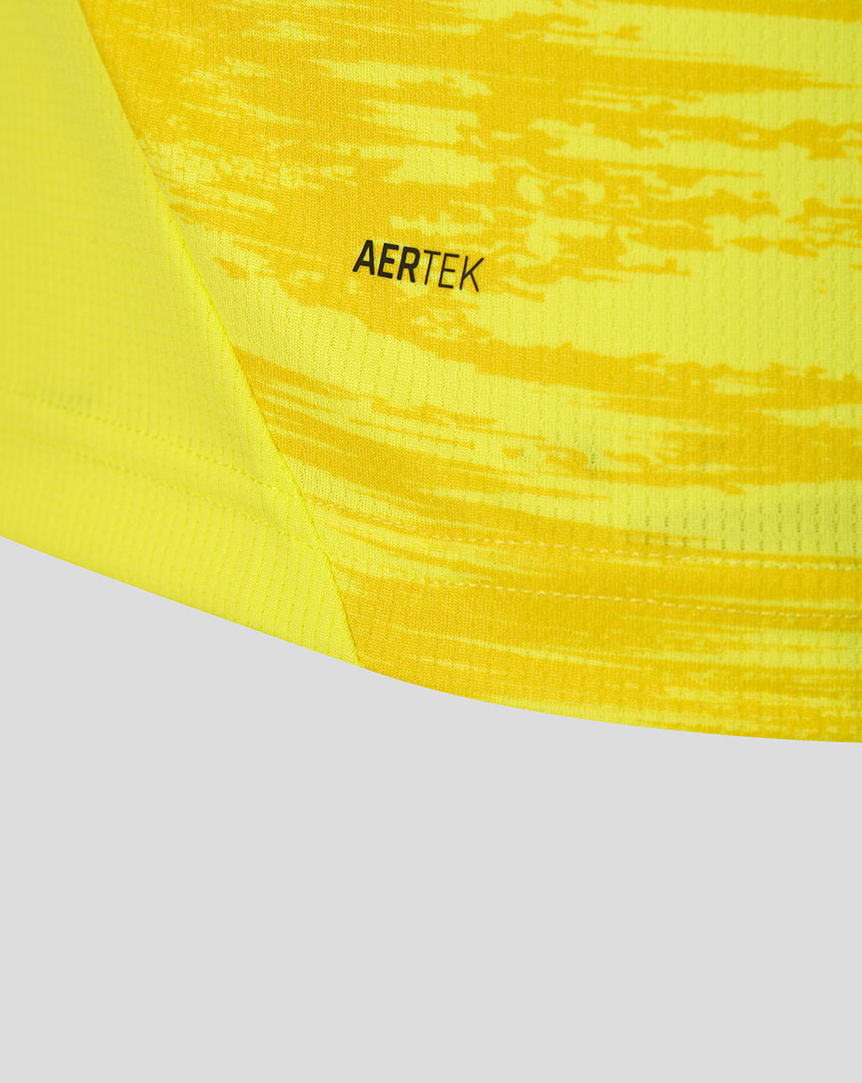 Close-up of bright yellow Feyenoord away goalkeeper shirt fabric with AERTEK branding.
