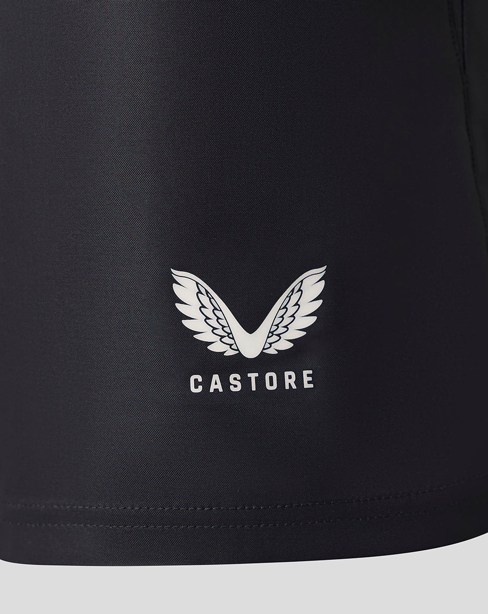 Close-up of a black athletic garment, likely shorts, featuring a white Castore wing logo and brand name printed on the front.