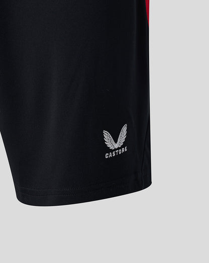 Close up of black athletic shorts with a white Castore logo near the hem.