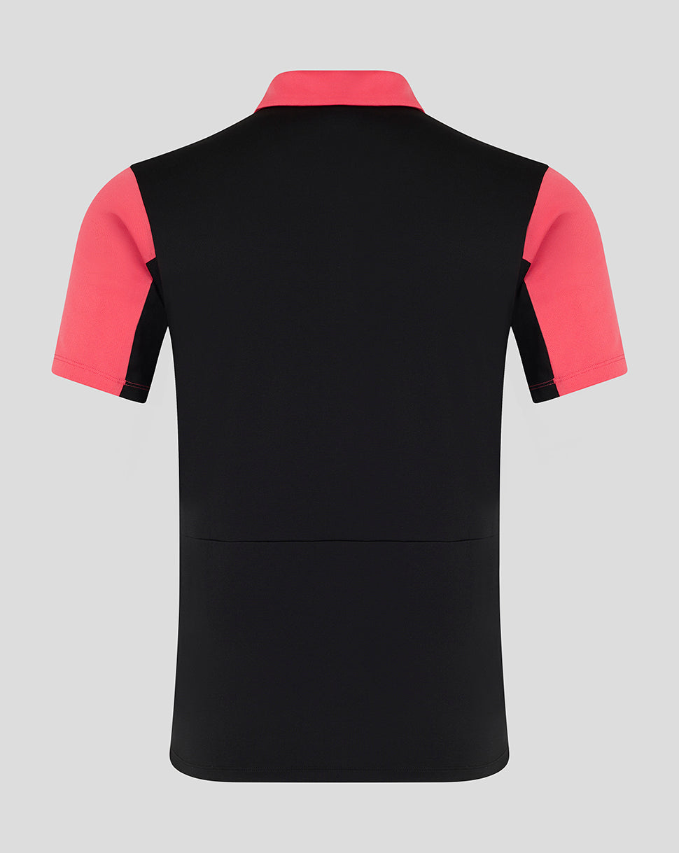 Black polo shirt with pink sleeves on a gray background