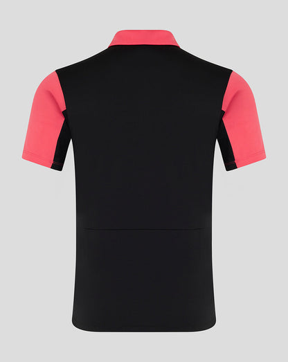 Black polo shirt with pink sleeves on a gray background
