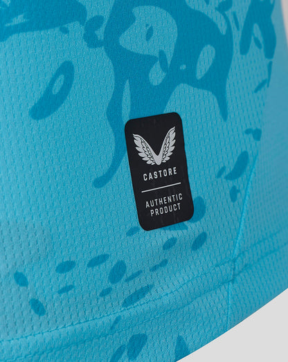 Close-up of Castore authentic product badge on turquoise FC Twente away goalkeeper shirt with subtle pattern