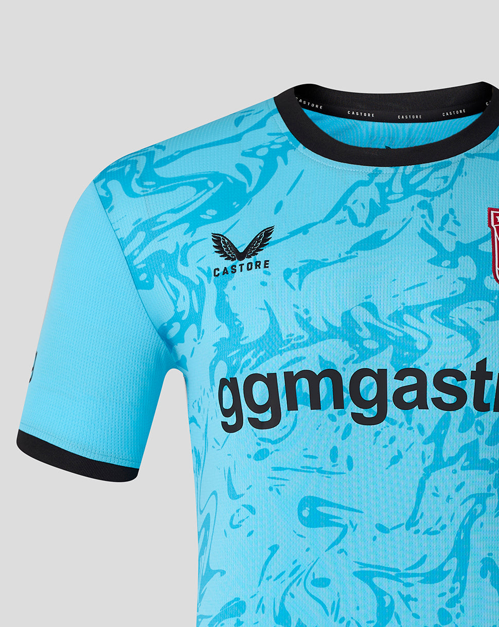 Left chest area of turquoise FC Twente away goalkeeper shirt with Castore logo and bold abstract pattern.
