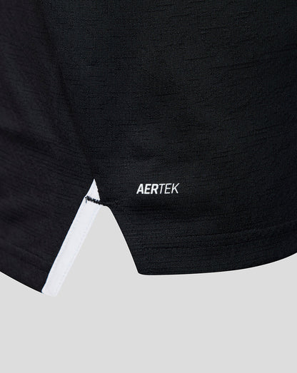 Close-up of the lower front of a black athletic shirt showing the AERTEK label and white trim at the hem