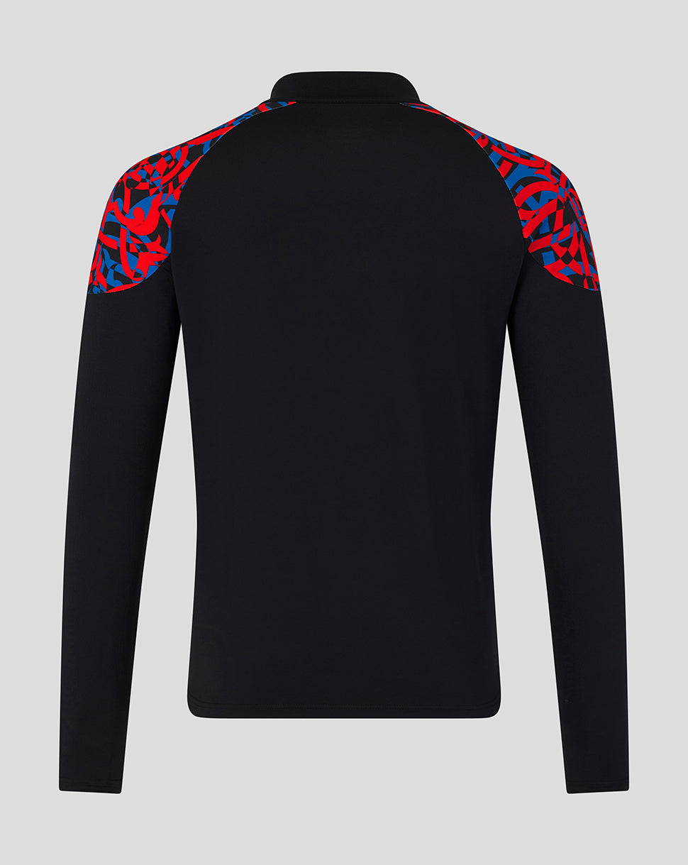 A black long-sleeve athletic top shown from the back, featuring a red and blue abstract patterned shoulder yoke, on a light gray background.