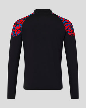 A black long-sleeve athletic top shown from the back, featuring a red and blue abstract patterned shoulder yoke, on a light gray background.