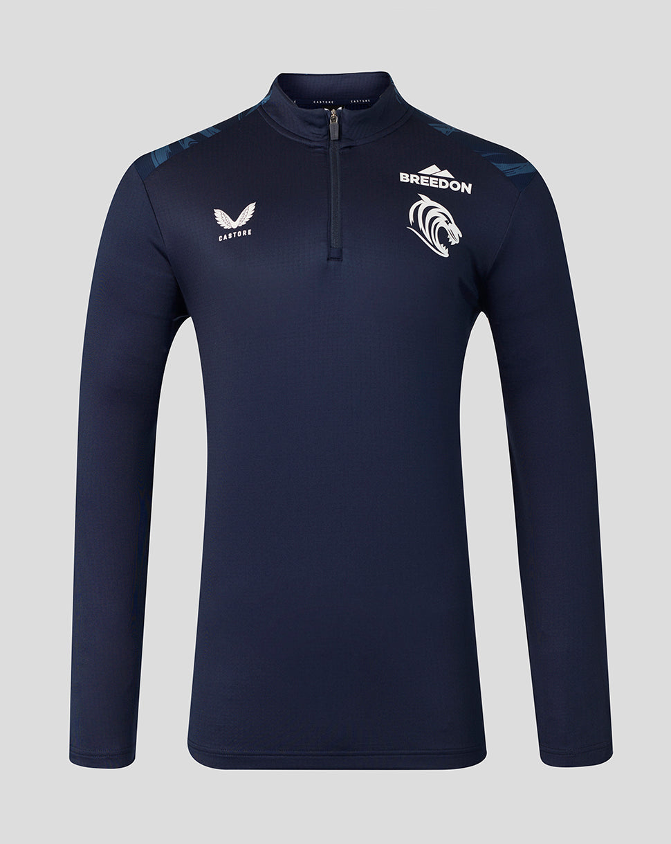 A navy blue long-sleeve quarter-zip athletic top with white branding, including the 'BREEDON' team logo and 'CASTORE' wing logo, displayed on a neutral gray background.
