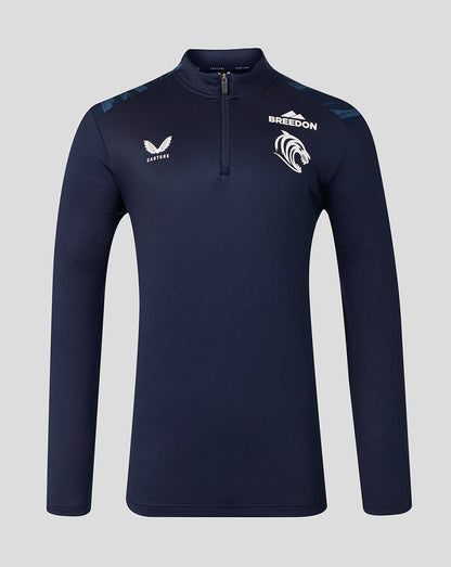 A navy blue long-sleeve quarter-zip athletic top with white branding, including the 'BREEDON' team logo and 'CASTORE' wing logo, displayed on a neutral gray background.