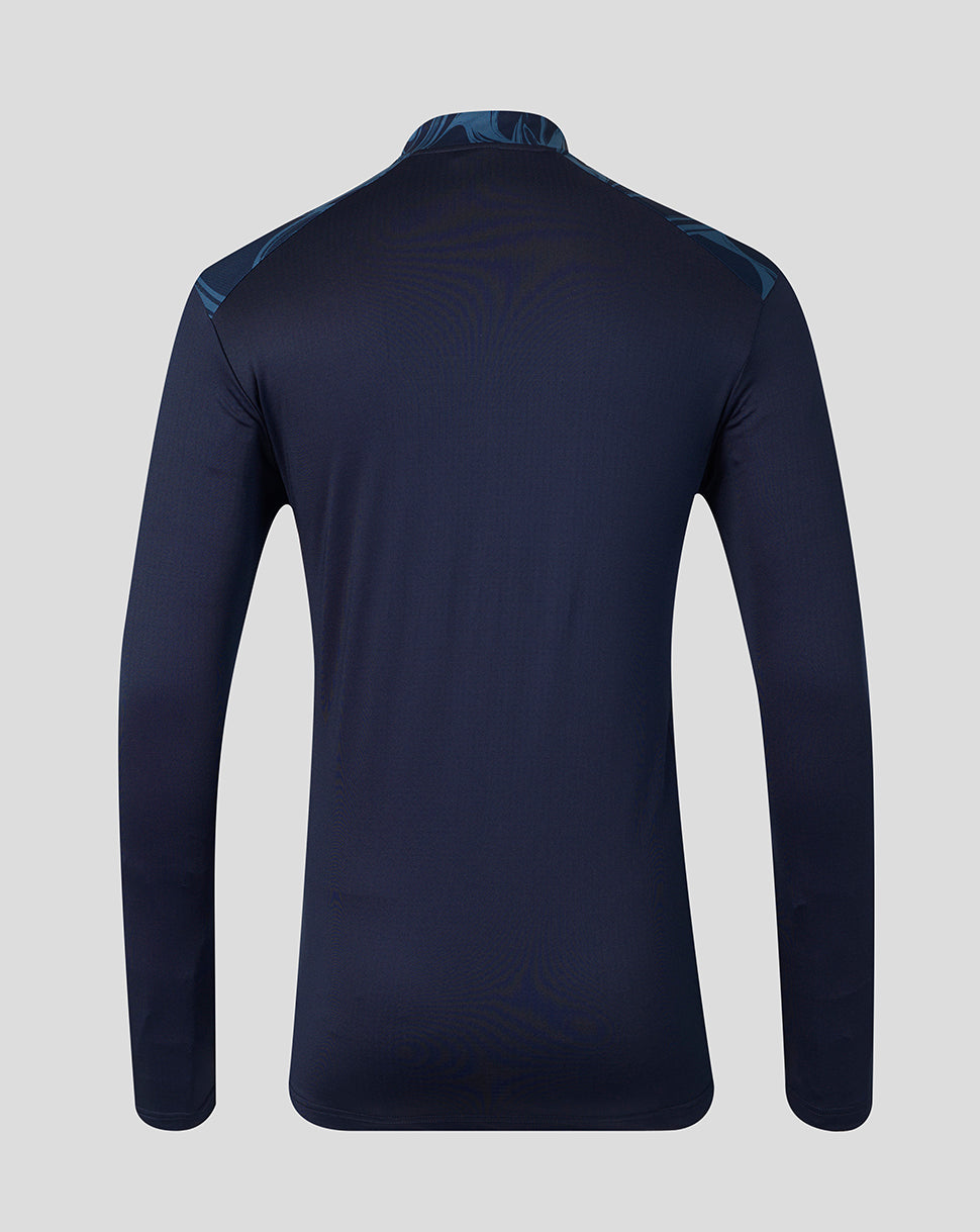 A dark navy long-sleeve athletic top shown from the back, featuring subtle tonal wave patterns and a subtle blue patterned collar and shoulder details, set against a solid light gray background.