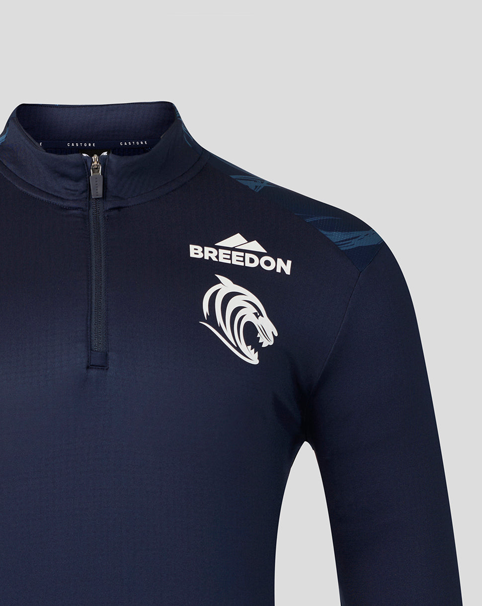 A close-up of a dark navy long-sleeve athletic quarter-zip pullover with a white 'BREEDON' text logo and a white stylized animal head graphic on the left chest, set against a solid light gray background.