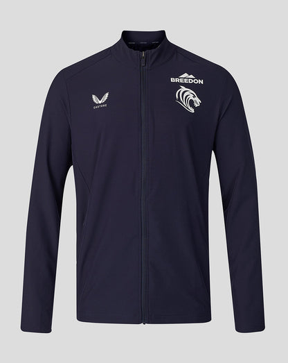 A navy blue full-zip athletic jacket with white printed logos on the chest, including 'BREEDON' and a mountain graphic, displayed against a solid gray background.