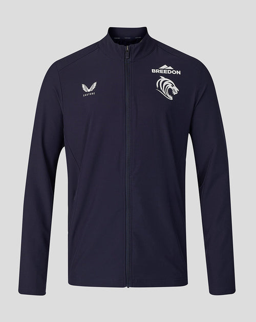 A navy blue full-zip athletic jacket with white printed logos on the chest, including 'BREEDON' and a mountain graphic, displayed against a solid gray background.