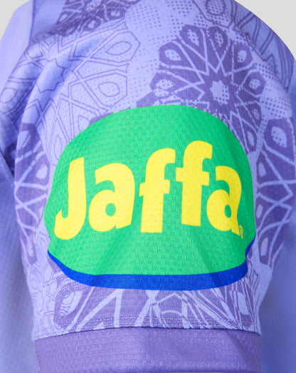Close-up of a purple patterned athletic jersey with a large green Jaffa logo patch and yellow Jaffa lettering on the front.