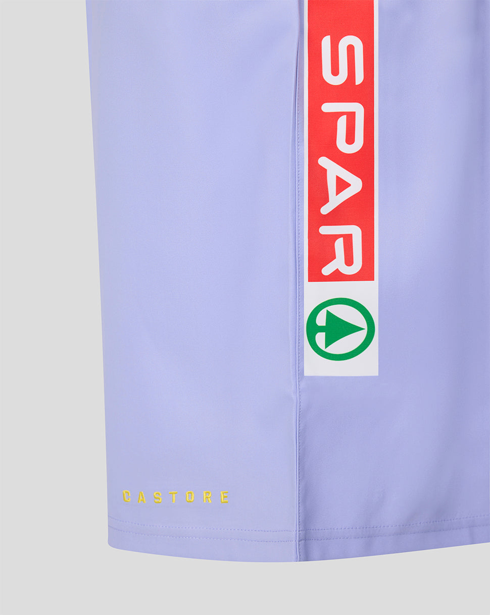 Close-up of a light lavender athletic shorts leg featuring a vertical red and white sponsor stripe with the word 'SPAR' and a green circular logo, plus small yellow 'CASTORE' text near the hem.