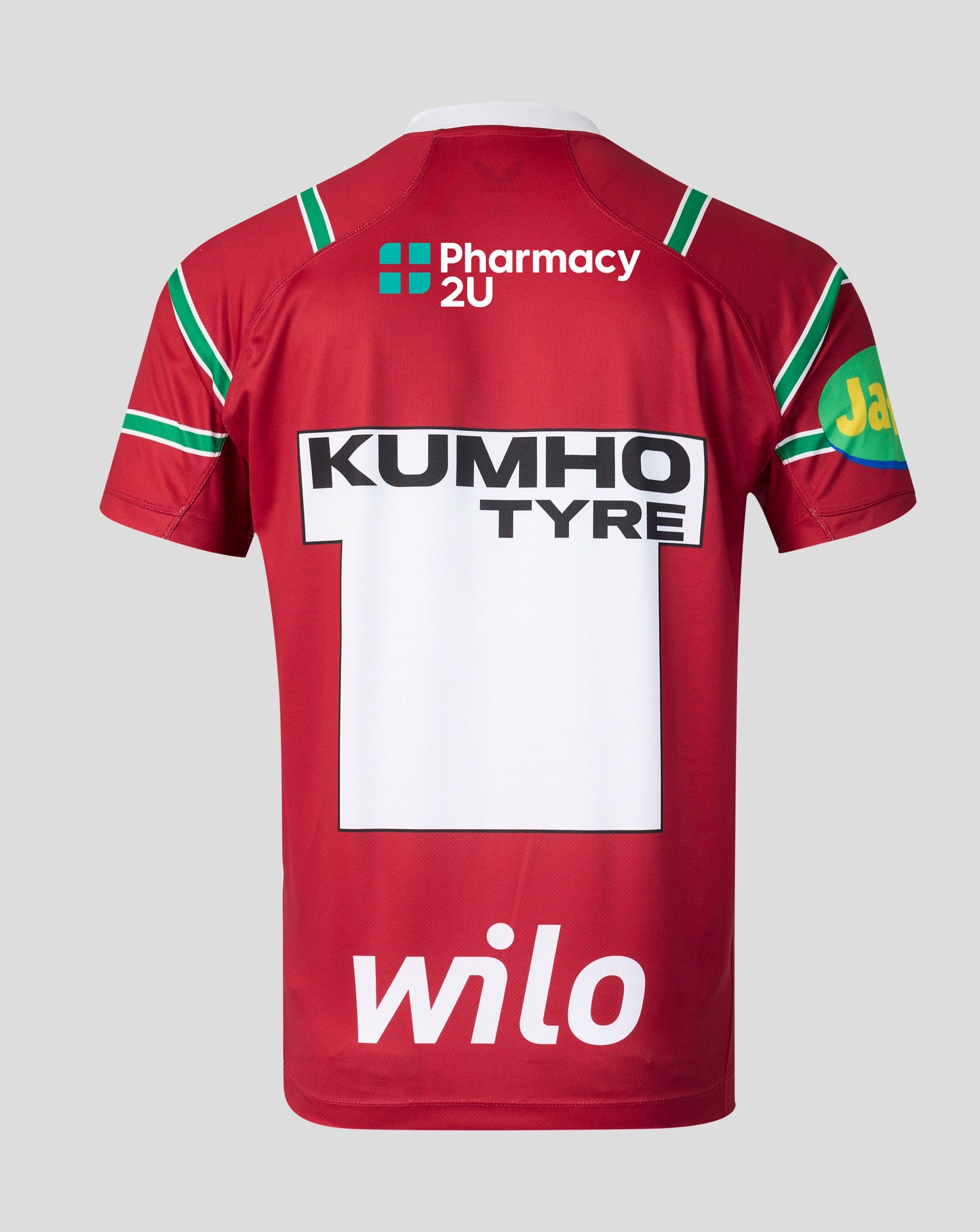 The back of a red short-sleeve sports jersey with green and white trim, featuring 'KUMHO TYRE' and 'Pharmacy 2U' sponsor logos, on a light gray background.