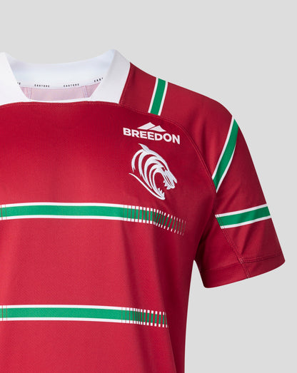 A close-up of a red short-sleeve rugby jersey with green and white stripes, featuring the word 'BREEDON' and a white wolf logo on the chest, set against a solid light gray background.