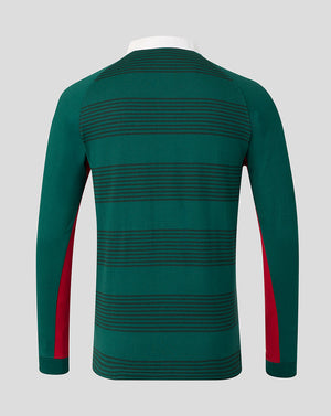 A long-sleeve knit top shown from the back, featuring horizontal dark green stripes on a dark green base with red side panels on the sleeves, displayed on a white mannequin torso against a light gray background.