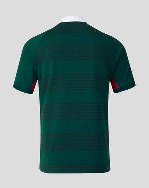 A dark green short-sleeve t-shirt with thin horizontal dark stripes across the back and red accents on the sleeve cuffs, shown on a neutral gray background.