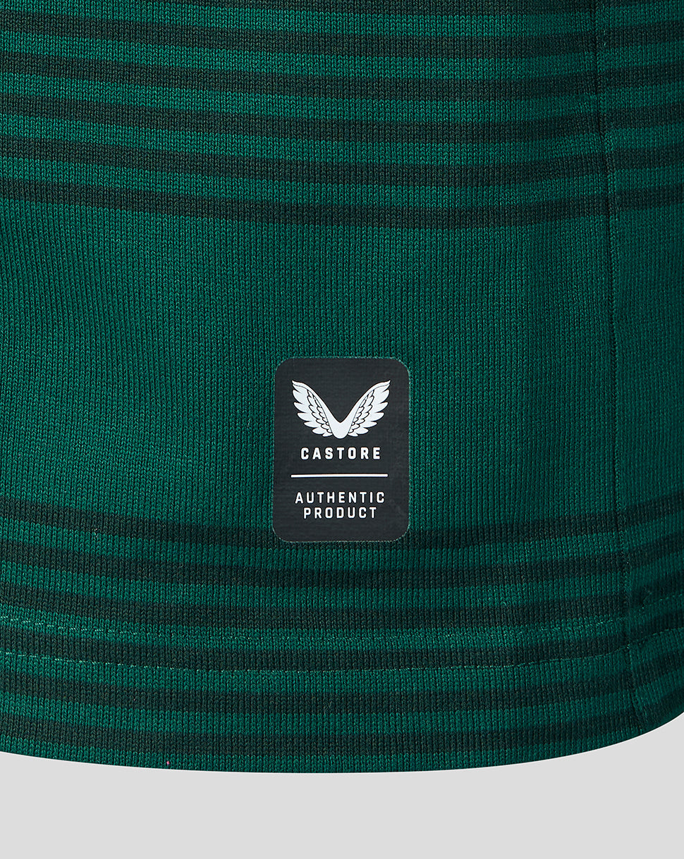Close-up of a dark green striped knit fabric with a black Castore brand patch on the front.